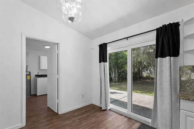 a view of a hallway with wooden floor and windows