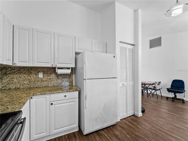 a white refrigerator freezer sitting inside of a kitchen
