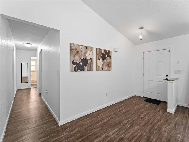 a view of a room with wooden floor
