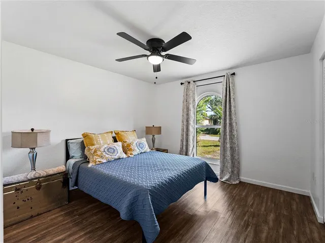 a bedroom with a bed and a window