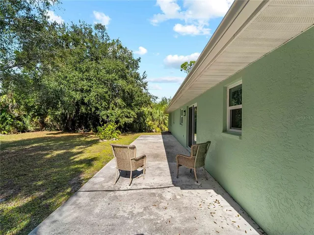 a view of a patio with a table and chairs