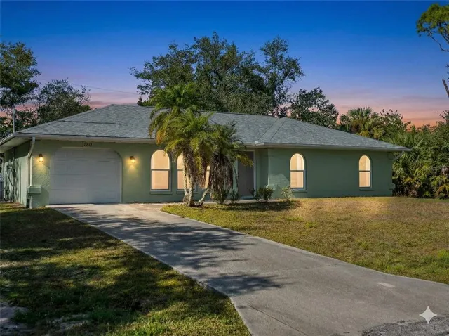 a front view of a house with a garden