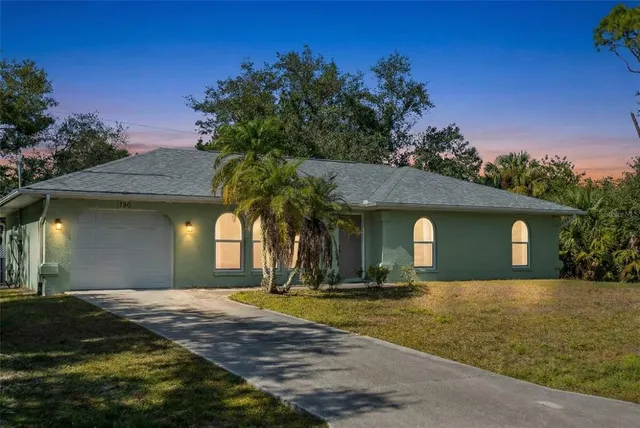 a house with swimming pool in front of it