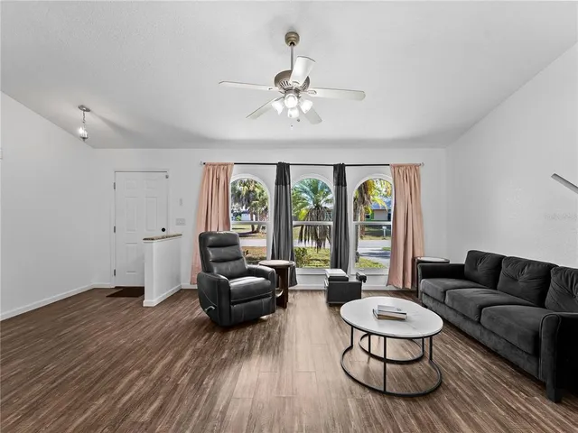 a living room with furniture and a large window