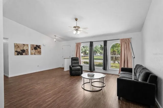 a living room with furniture and a floor to ceiling window