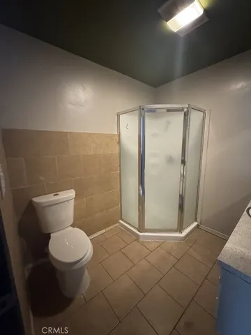 a bathroom with a toilet and a shower
