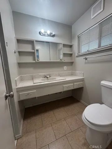 a bathroom with a sink a toilet and vanity