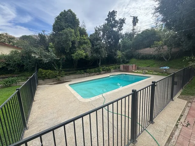 a view of a balcony with wooden floor and fence