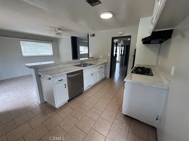 a kitchen with a sink a stove and cabinets