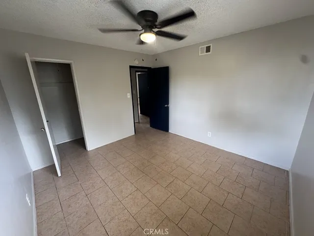 a view of a livingroom with a ceiling fan and window