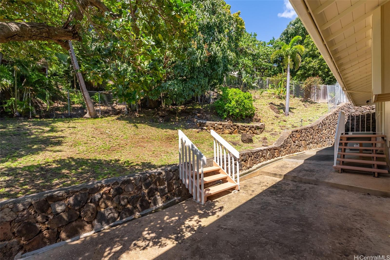 1350 Laukahi Street Honolulu, HI 96821 - Photo 22 of 25 Enjoy a peaceful backyard setting with a fruiting mango tree and terraced landscape, offering privacy and space