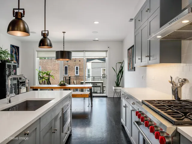 a kitchen with stove a sink and cabinets