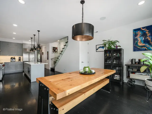 a living room with dining table and a table