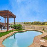 a view of a swimming pool with a patio