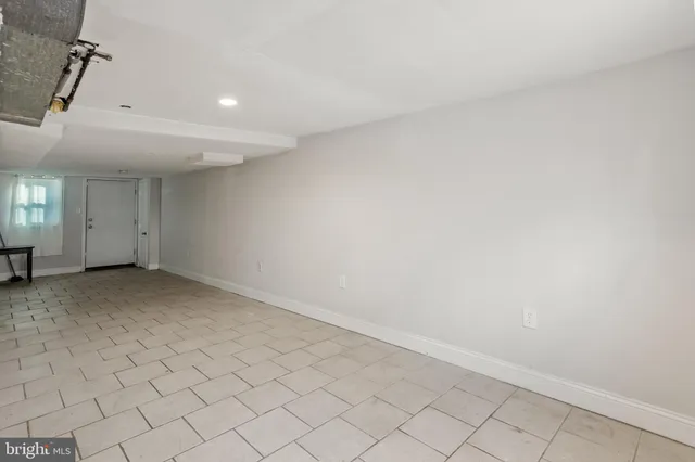an empty room with white walls and tiles