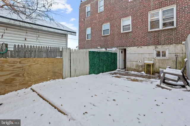 a view of a backyard with seating space