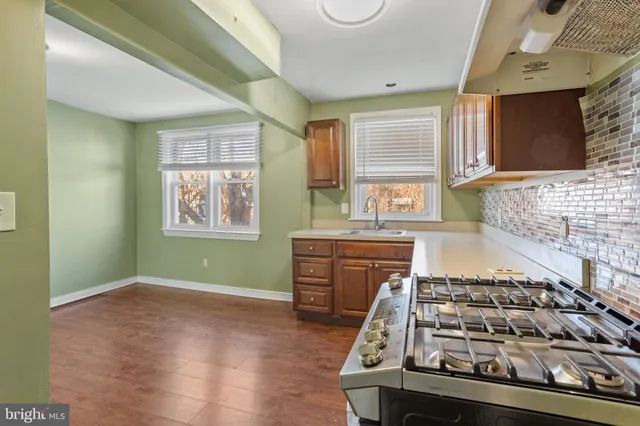 a kitchen with wooden cabinets and a stove top oven