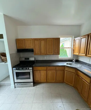 a kitchen with granite countertop a sink and a stove