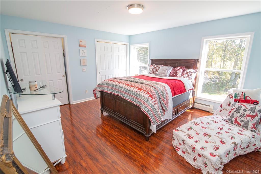 82 Fowler Road North Stonington, CT 06359 - Photo 25 of 36 a spacious bedroom with a bed and wooden floor