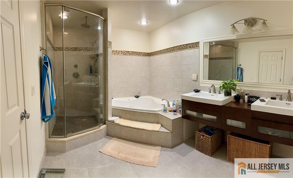 238 Nebula Road, Unit 238 Piscataway, NJ 08854 - Photo 17 of 22 a bathroom with a tub shower sink and mirror