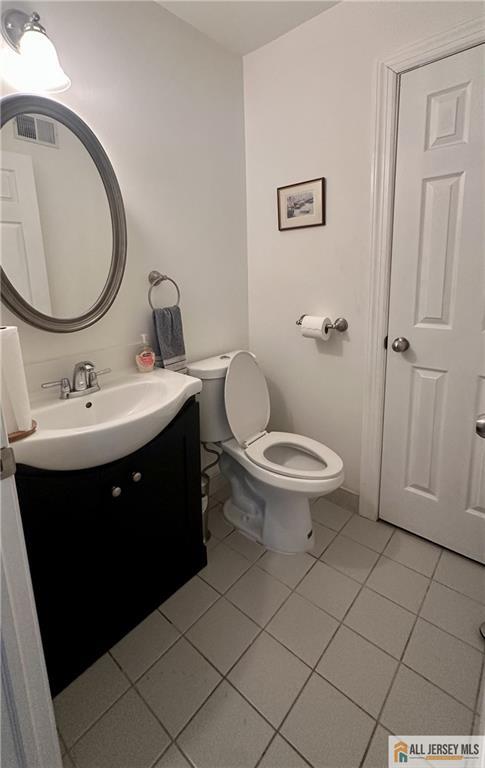 238 Nebula Road, Unit 238 Piscataway, NJ 08854 - Photo 9 of 22 a bathroom with a sink a toilet and a mirror