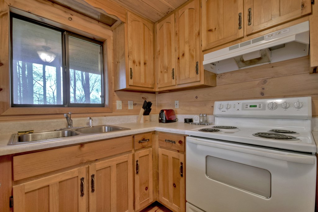 1285 Walnut Ridge Ellijay, GA 30536 - Photo 13 of 38 a kitchen with stainless steel appliances granite countertop a sink stove and cabinets