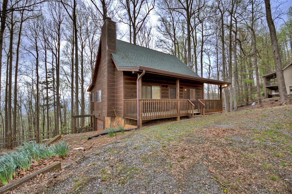 1285 Walnut Ridge Ellijay, GA 30536 - Photo 2 of 38 a front view of a house with a yard and garage
