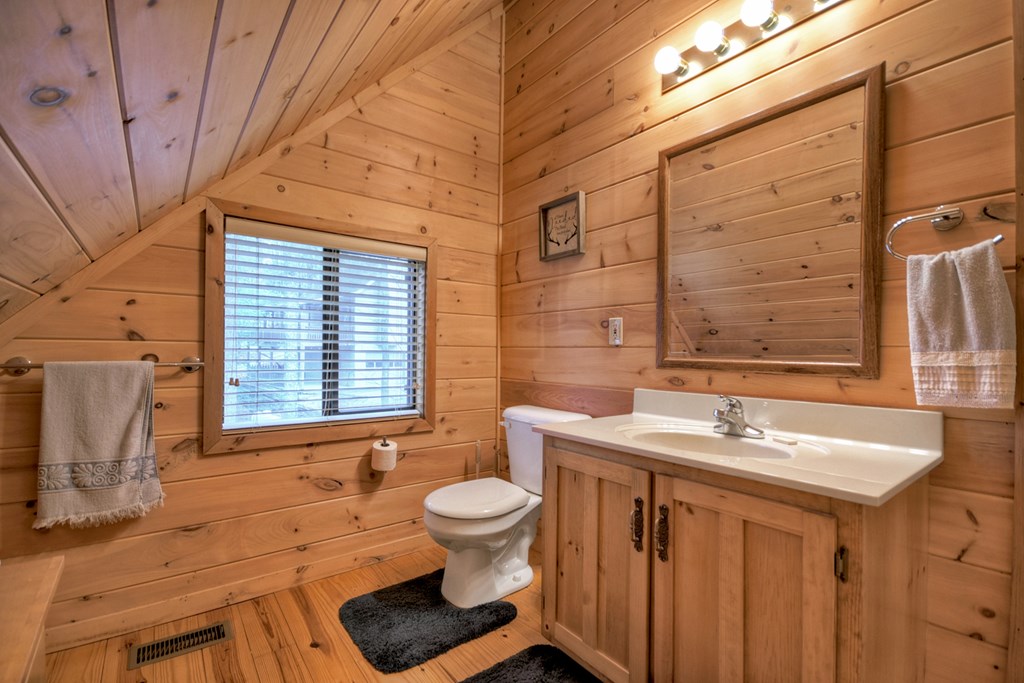 1285 Walnut Ridge Ellijay, GA 30536 - Photo 25 of 38 a bathroom with a sink a toilet and mirror