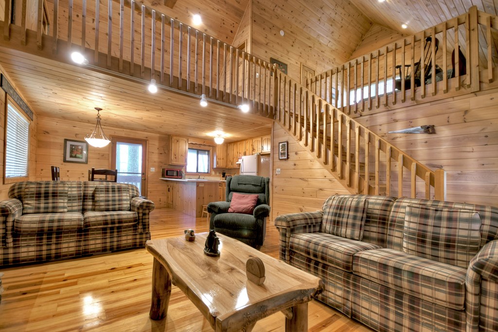 1285 Walnut Ridge Ellijay, GA 30536 - Photo 7 of 38 a living room with couches and kitchen view with wooden floor