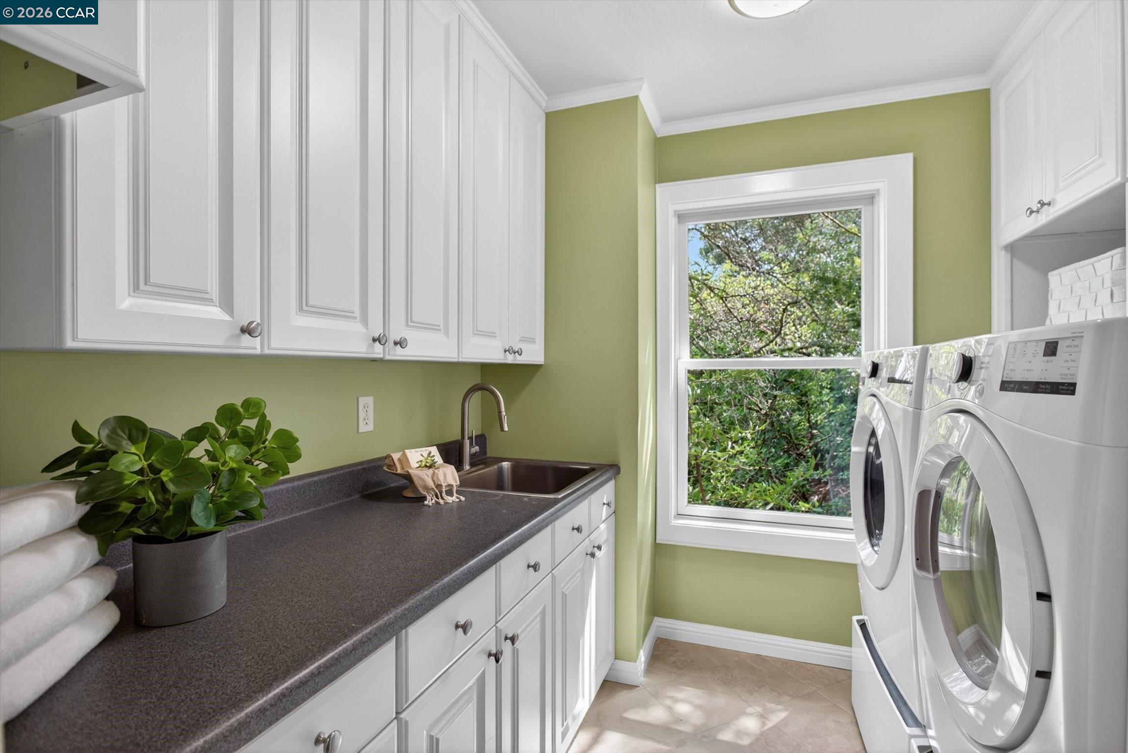 4105 Coralee Lane Lafayette, CA 94549 - Photo 35 of 43 a kitchen with a sink a washer and dryer