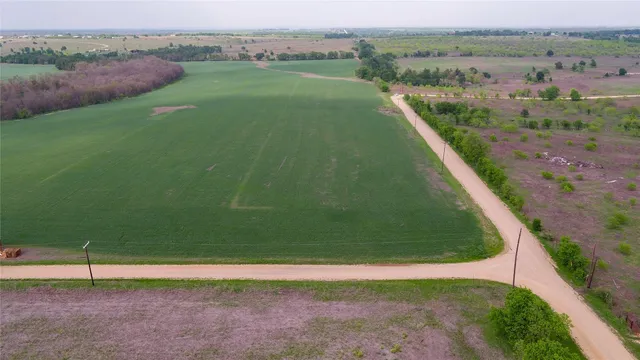 a view of a water pond with green field