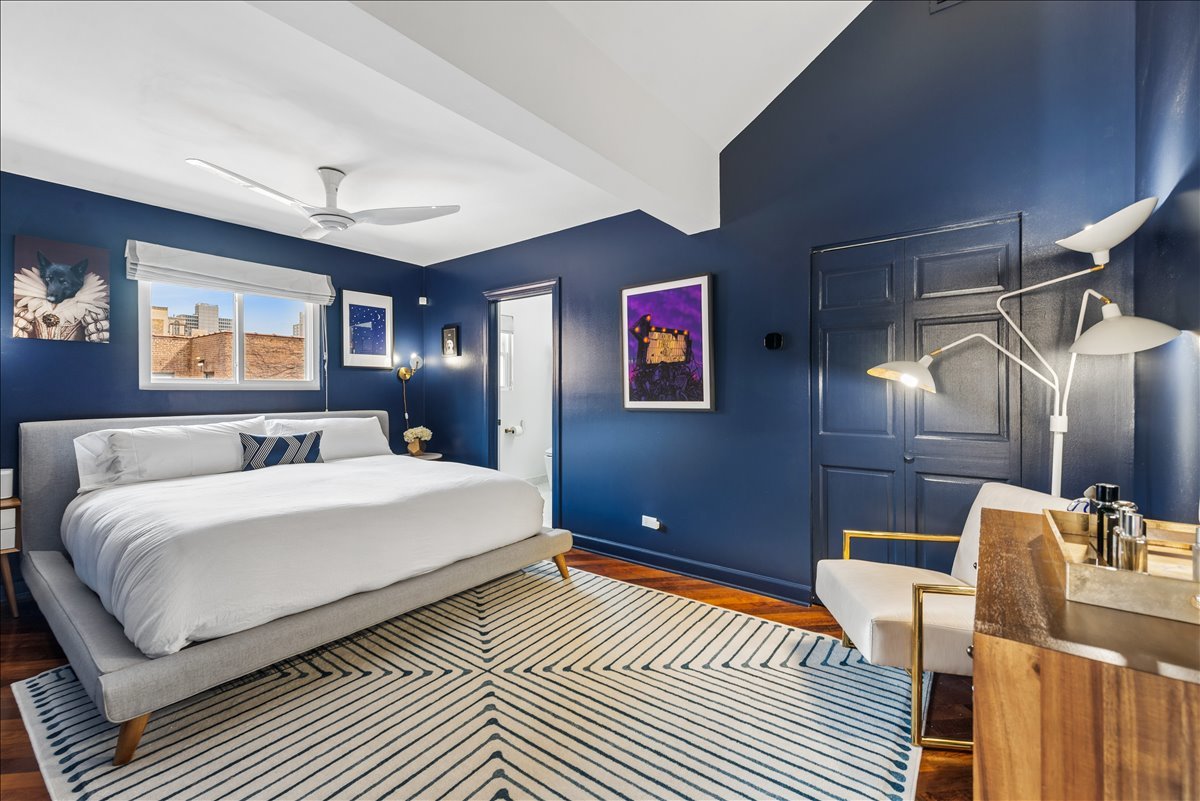561 West Briar Place, Unit 305 Chicago, IL 60657 - Photo 13 of 23 a spacious bedroom with a bed and a chandelier