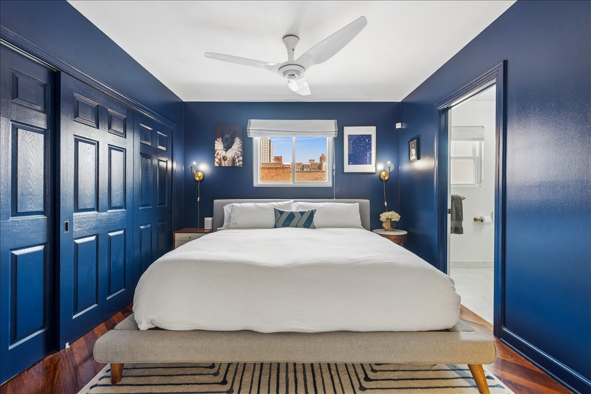 561 West Briar Place, Unit 305 Chicago, IL 60657 - Photo 14 of 23 a bedroom with a large bed and a chandelier
