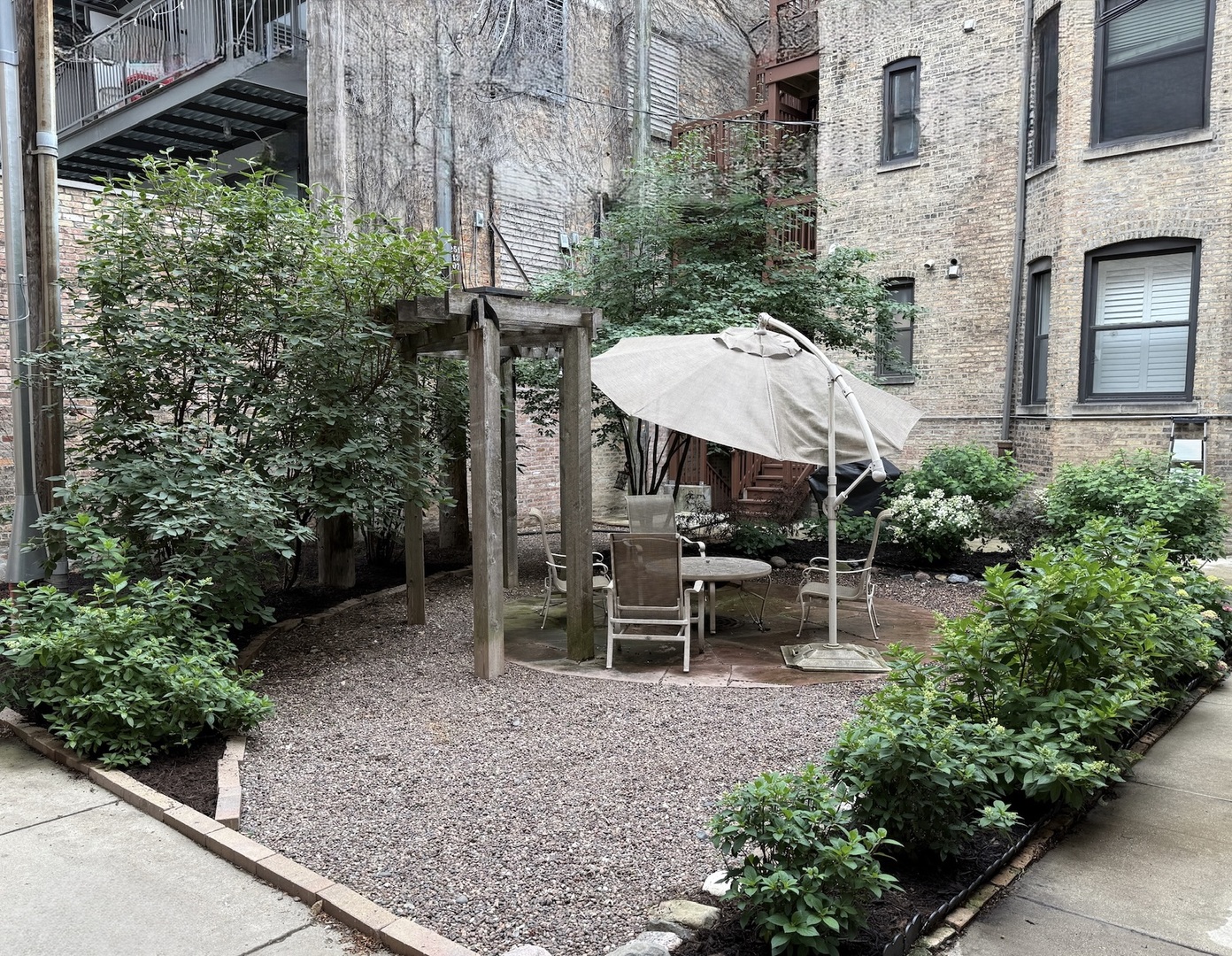 561 West Briar Place, Unit 305 Chicago, IL 60657 - Photo 23 of 23 a view of a patio with chairs and plants