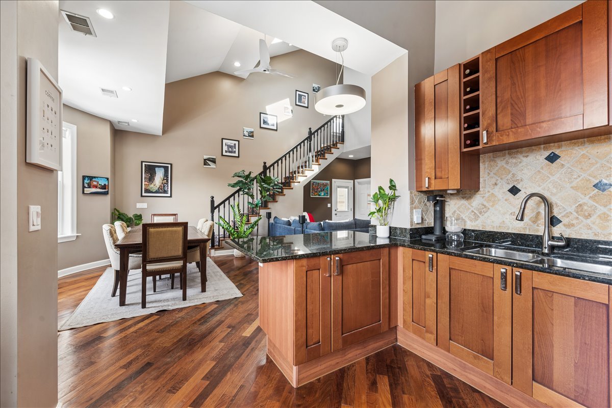 561 West Briar Place, Unit 305 Chicago, IL 60657 - Photo 9 of 23 a kitchen with granite countertop a table chairs stove and cabinets