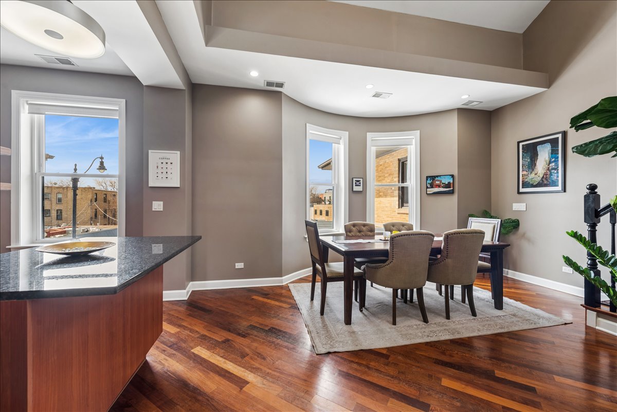 561 West Briar Place, Unit 305 Chicago, IL 60657 - Photo 10 of 23 a view of a dining room with furniture window and wooden floor