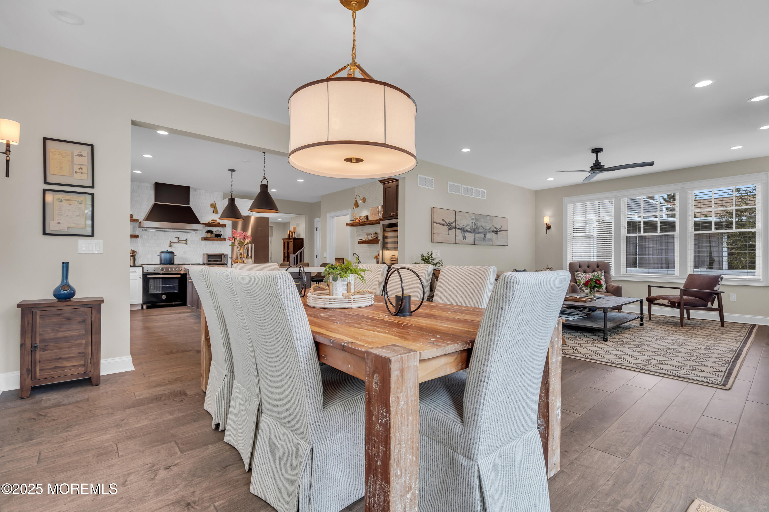 2118 Edgewood Place Spring Lake, NJ 07762 - Photo 45 of 67 a view of dining room and livingroom with furniture wooden floor a rug a painting and a chandelier