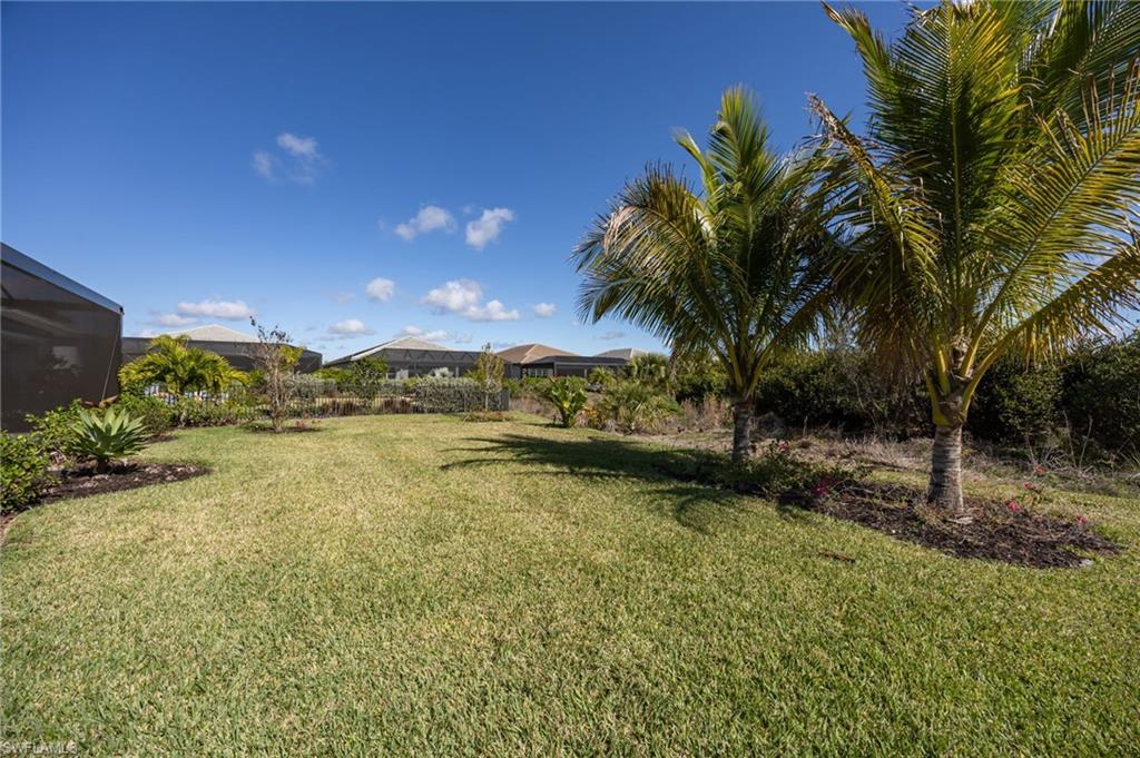 12128 Eucalyptus Way Naples, FL 34120 - Photo 25 of 47 12128 Eucalyptus Way enjoys TWO views from the outdoor living space! Landscaped preserve to the left; lake views to the right.