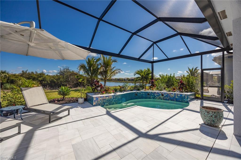 12128 Eucalyptus Way Naples, FL 34120 - Photo 28 of 47 12128 Eucalyptus Way enjoys TWO views from the outdoor living space! Landscaped preserve to the left; lake views to the right.