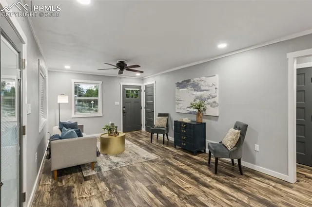 a living room with furniture and wooden floor