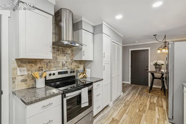 a kitchen with stainless steel appliances granite countertop a sink stove and refrigerator