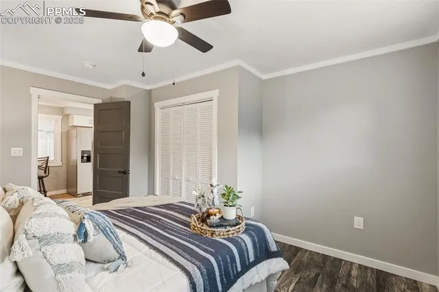 a bedroom with a bed and a chandelier fan