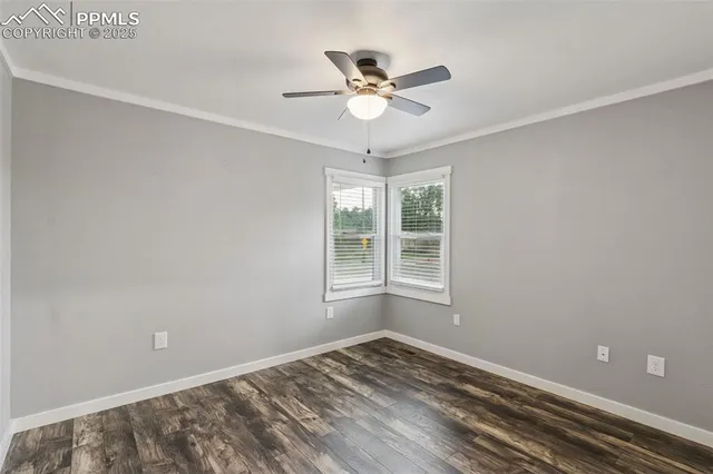 a view of a room with a ceiling fan and window