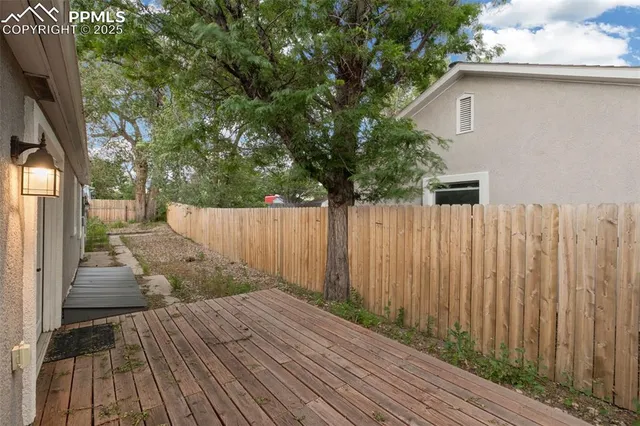 a view of a backyard with wooden fence