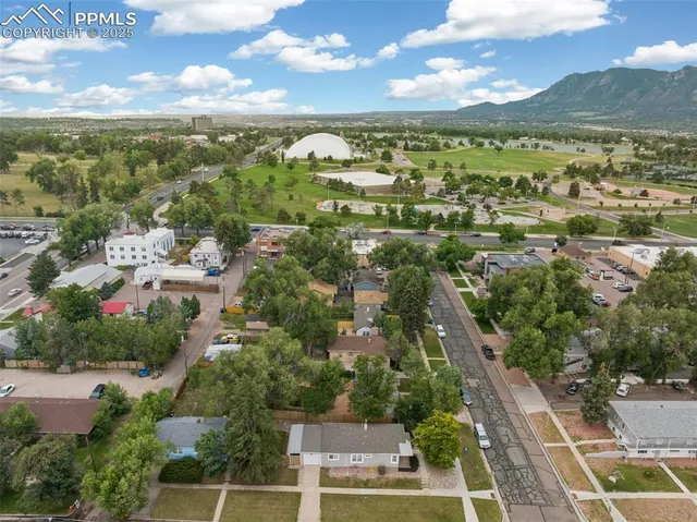 an aerial view of residential houses with outdoor space and ocean view