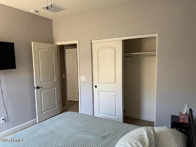 a view of a livingroom with wooden floor and a flat screen tv