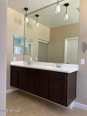 a bathroom with a shower and a sink