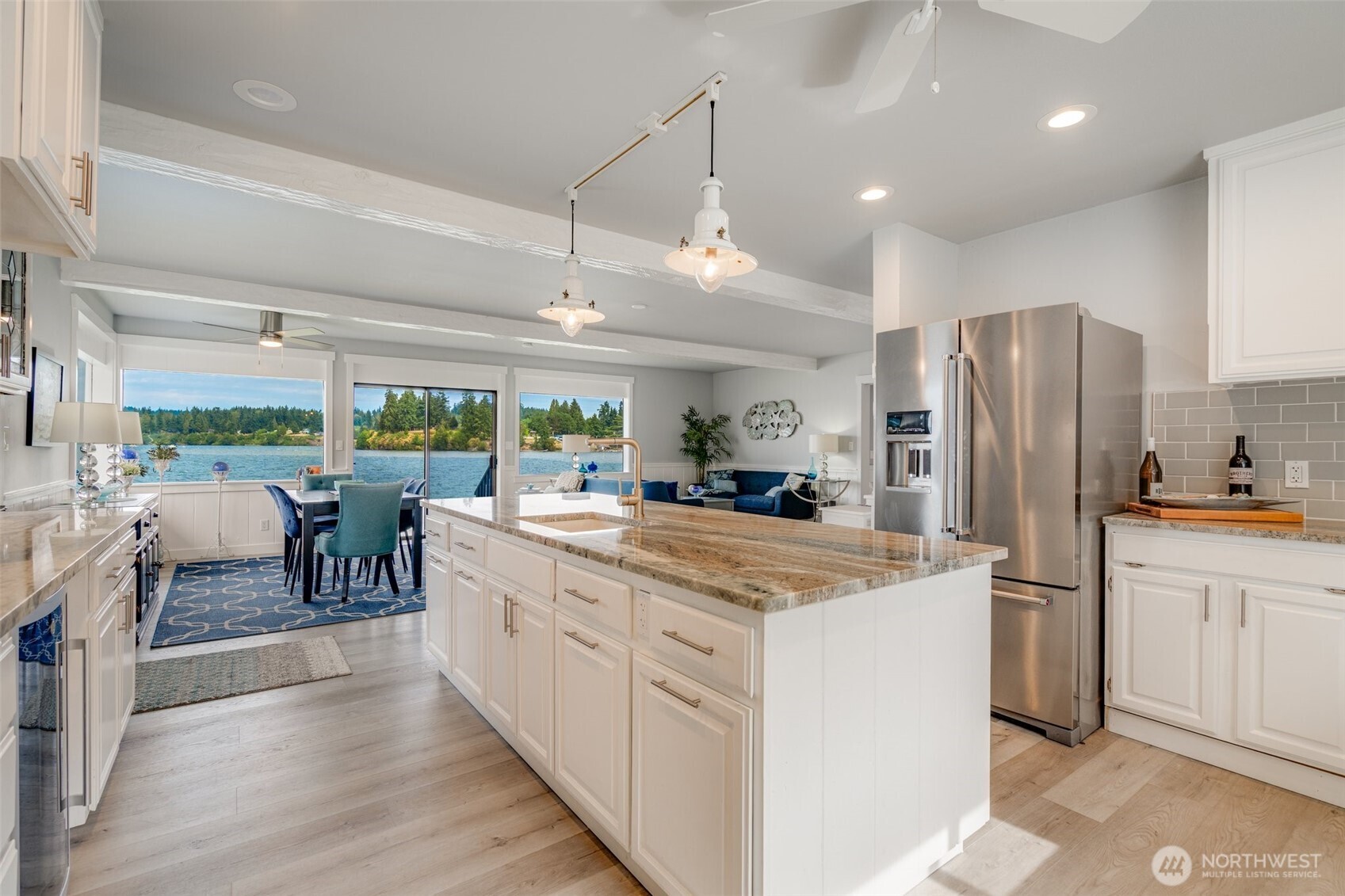5341 South Bercot Road Freeland, WA 98249 - Photo 10 of 37 a kitchen with kitchen island a large counter top space appliances and cabinets