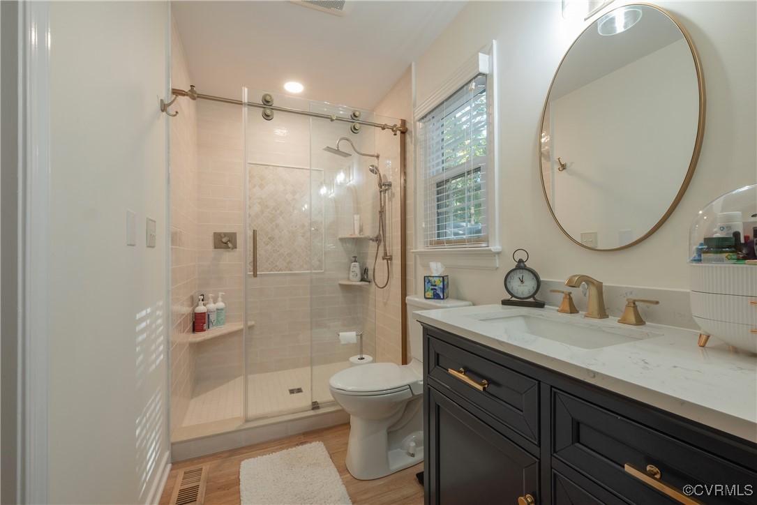 5812 Ridge Point Road Midlothian, VA 23112 - Photo 36 of 45 a bathroom with a double vanity sink toilet mirror and shower