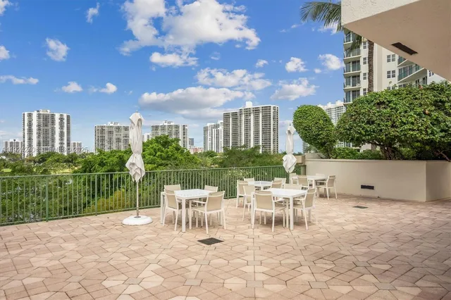 a view of a chair and tables in the patio
